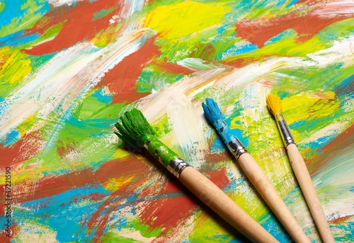 Paintbrushes on abstract grange background