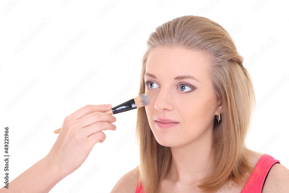 young beautiful woman with make-up brush over white young beautiful woman with make-up brush over white