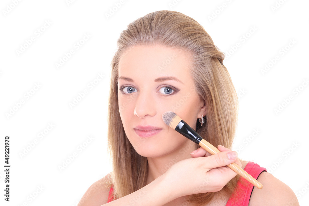young woman with make-up brush over white