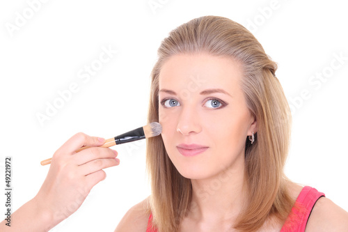 beautiful girl with make-up brush over white