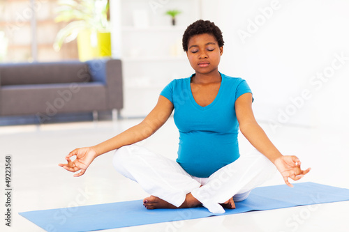 pregnant african american woman meditation at home