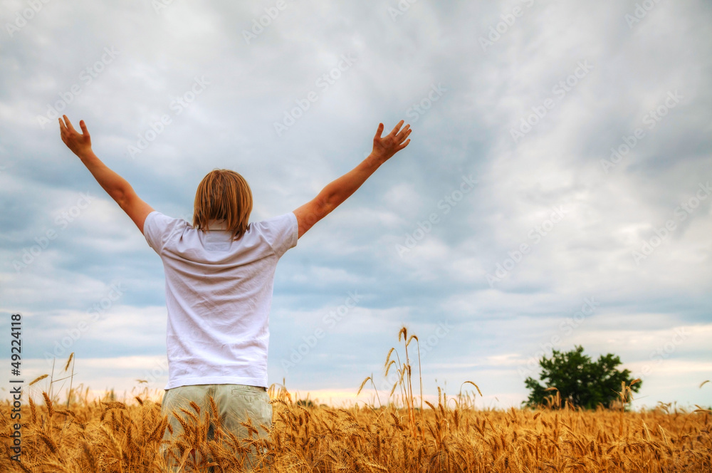 Young man staying with raised hands Young man staying with raised hands