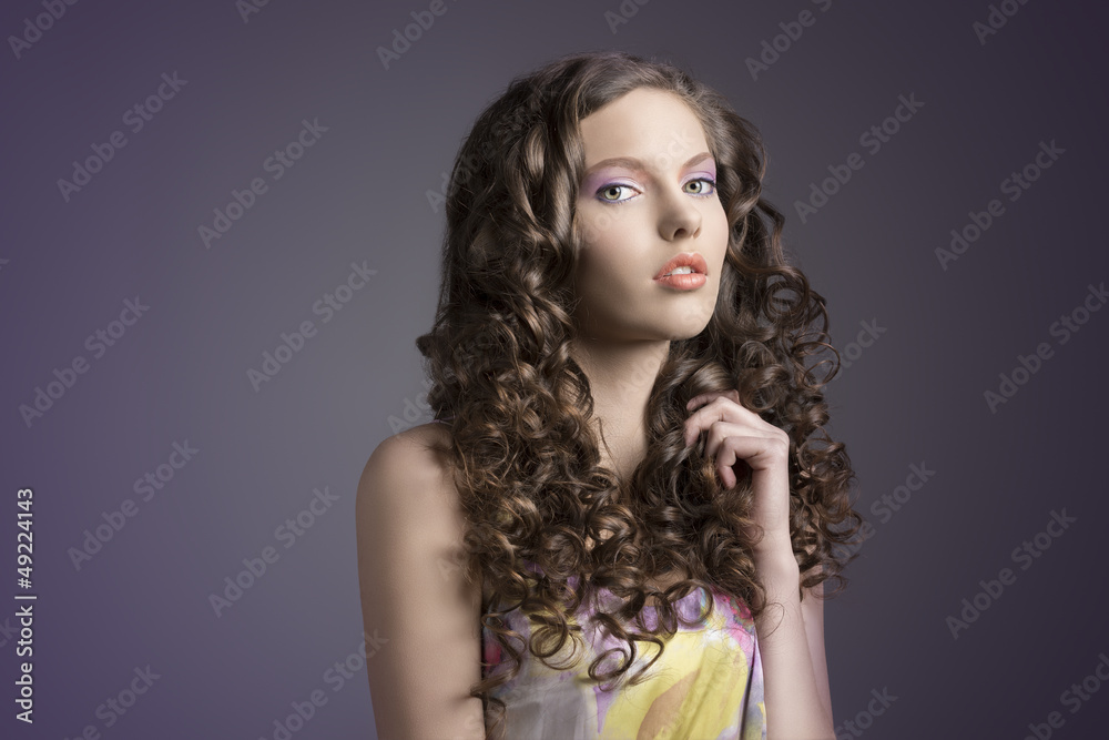 pretty brunette with curly hairturned of three quarters