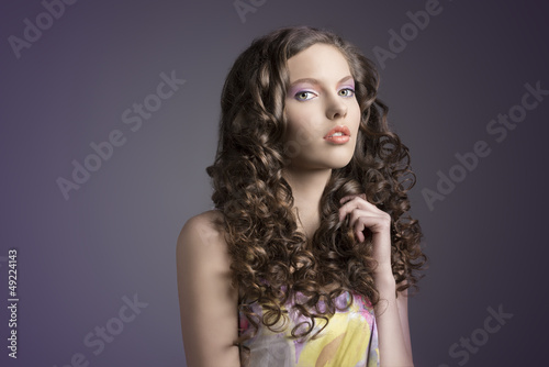 pretty brunette with curly hairturned of three quarters