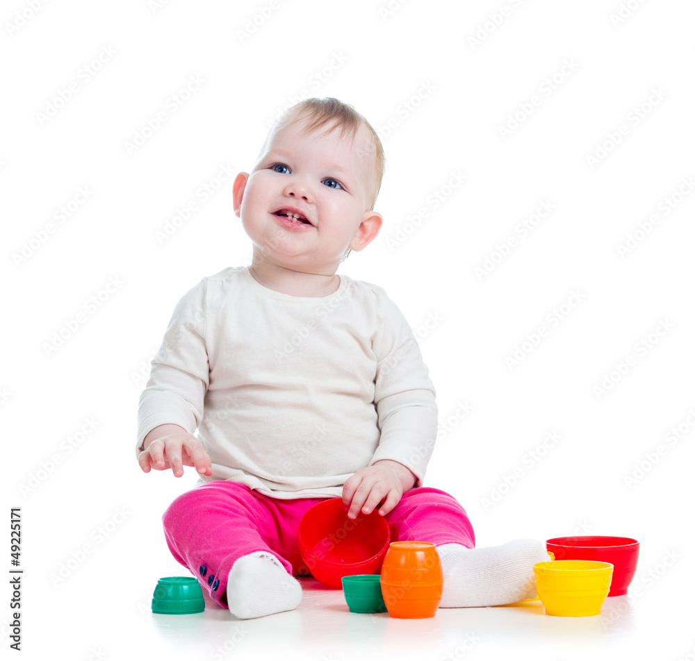 baby girl playing with toys while sitting on floor, isolated ove baby girl playing with toys while sitting on floor, isolated ove