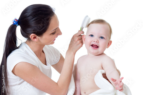 mother is combing kid`s hai...
