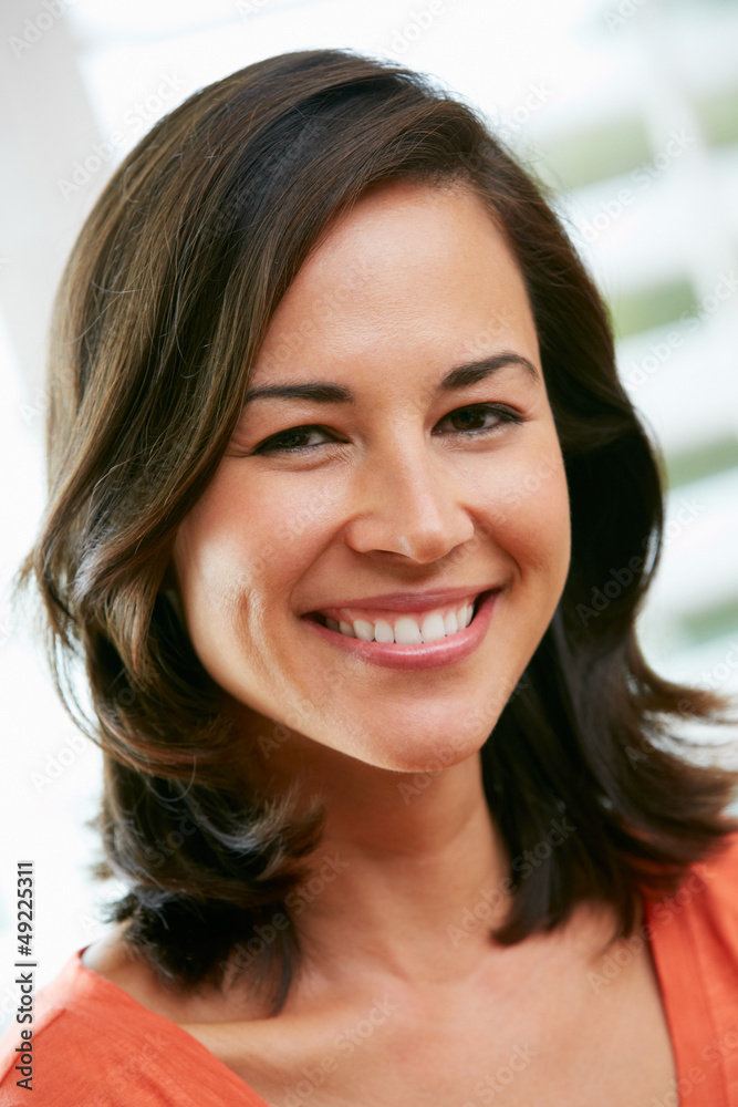 Portrait Of Happy Hispanic Woman At Home