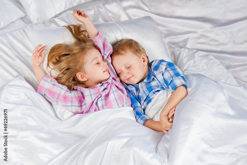 Happy little boy and girl in bed Happy little boy and girl in bed