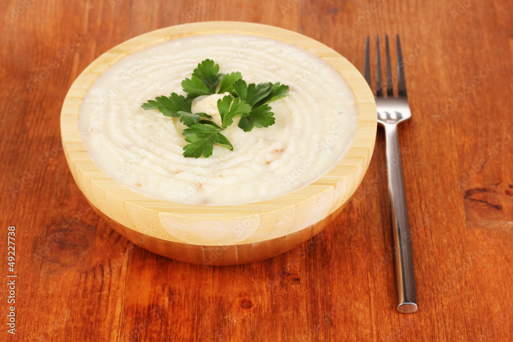 Mashed potatoes in wooden bowl on table close-up Mashed potatoes in wooden bowl on table close-up