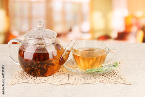 Exotic green tea with flowers in glass teapot