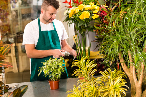 Man florist reading price barcode reader flower photo