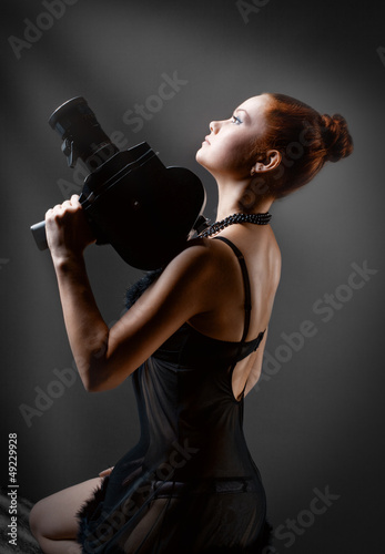 woman with old camera in studio