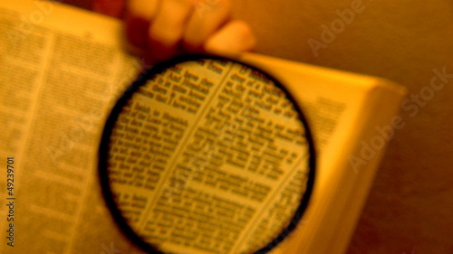 book through a magnifying glass