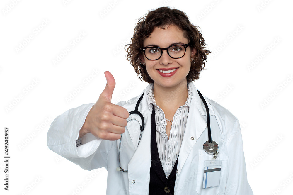 Successful young doctor showing thumbs up Successful young doctor showing thumbs up