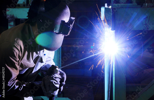 Industrial worker welding steel structure in factory,welding spa