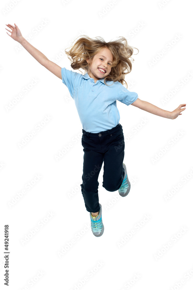 Energetic young child jumping high Energetic young child jumping high