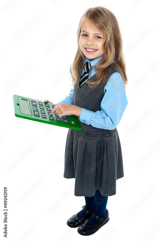 Schoolkid pressing key 5 on big green calculator Schoolkid pressing key 5 on big green calculator