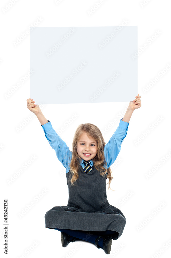 Sweet kid holding blank ad board above her head Sweet kid holding blank ad board above her head