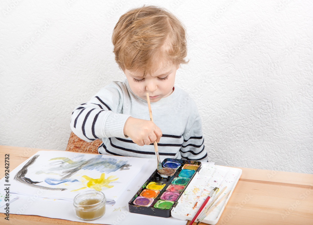 Cute little boy of two years having fun painting Cute little boy of two years having fun painting
