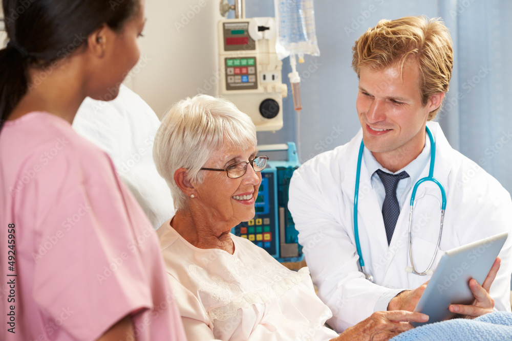 Doctor Using Digital Tablet In Consultation With Patient