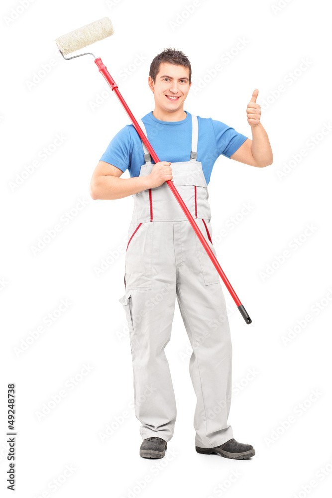 Male painter holding a roller and giving a thumb up Male painter holding a roller and giving a thumb up