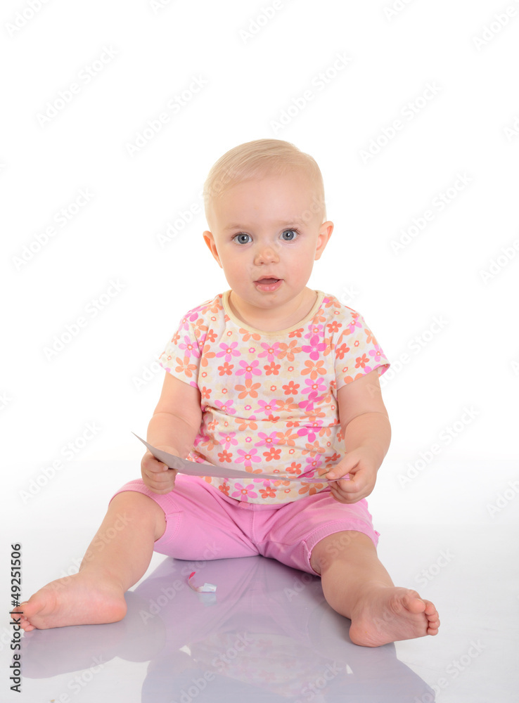 Baby playing with a picture on white background Baby playing with a picture on white background