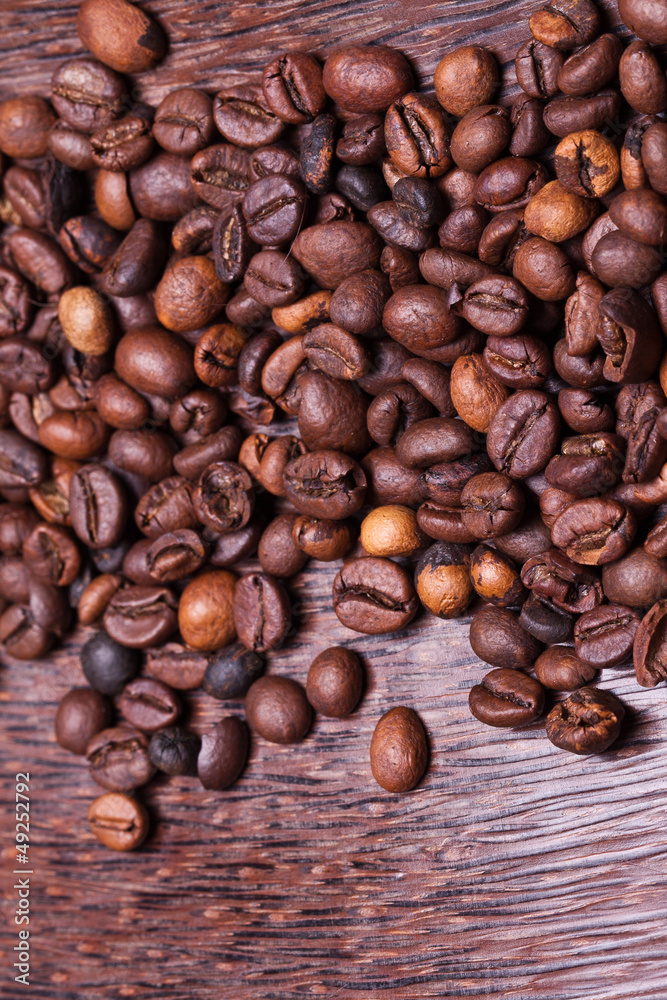 coffee beans on the background of mango wood. coffee beans on the background of mango wood.