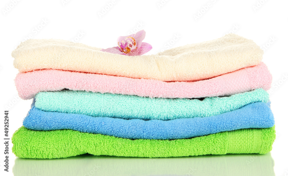 Stack of towels with fragrant flower isolated on white Stack of towels with fragrant flower isolated on white