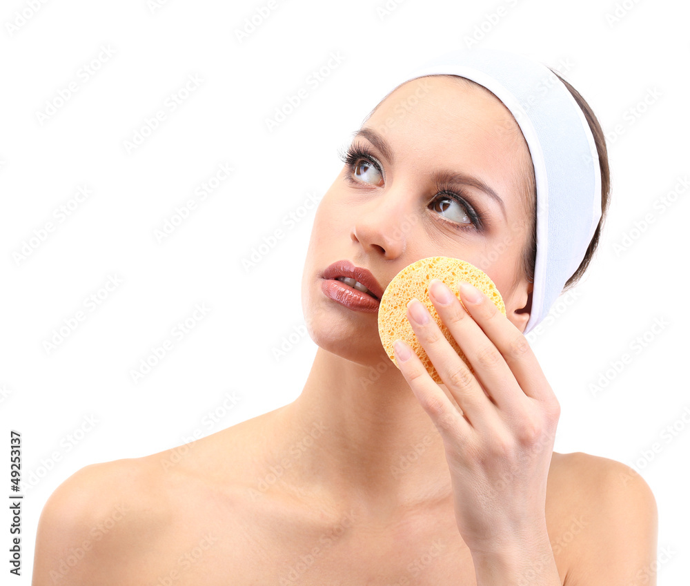 Young woman cleansing her face, isolated on white Young woman cleansing her face, isolated on white