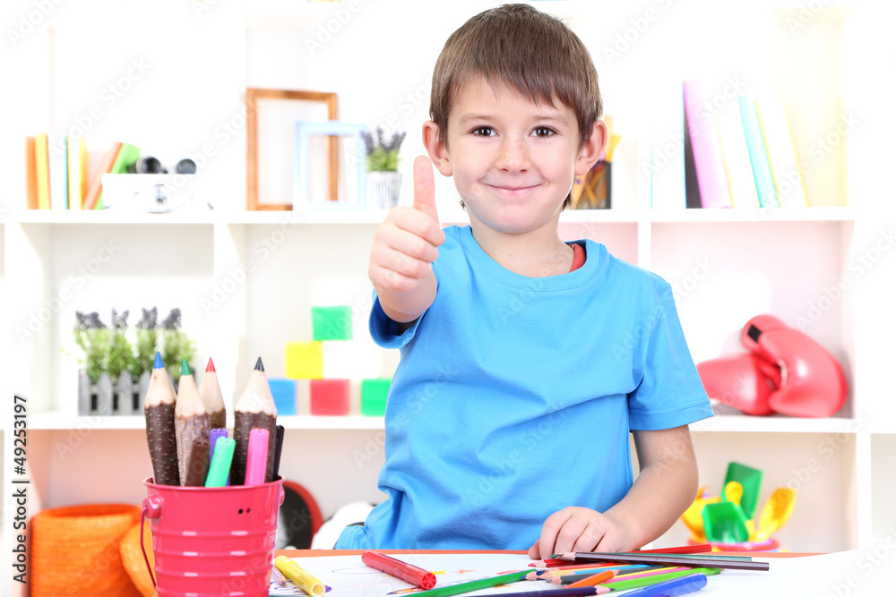 Cute little boy drawing in his album Cute little boy drawing in his album