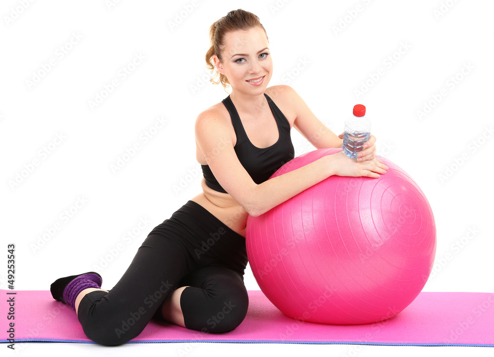 Young woman with gym ball and water isolated on white