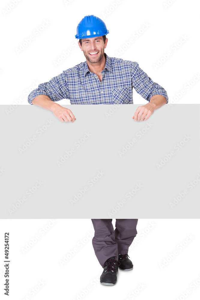 Portrait of happy worker presenting empty banner Portrait of happy worker presenting empty banner