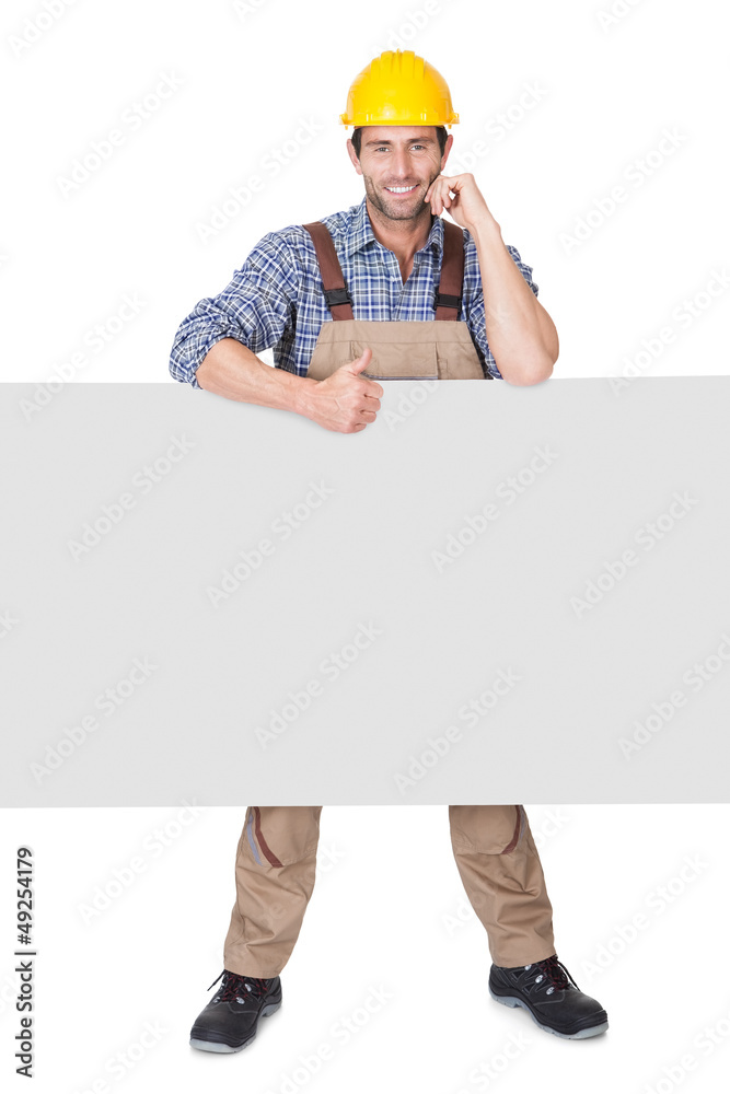 Construction worker presenting empty banner Construction worker presenting empty banner