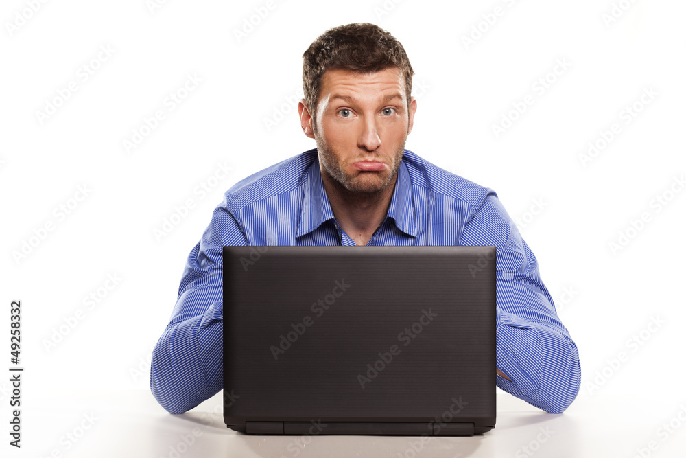 confused man on a laptop with a face gesture confused man on a laptop with a face gesture