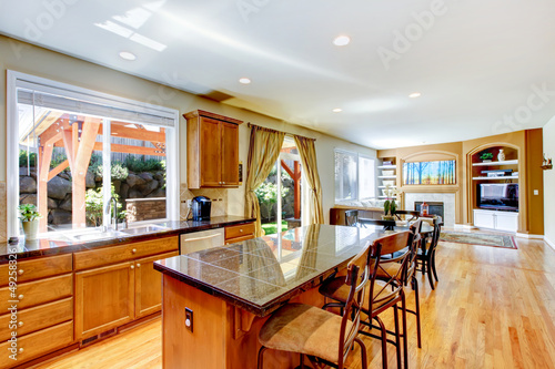 Wood classic large kitchen with granite island.