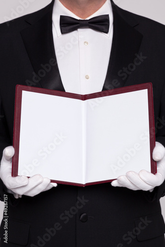 Waiter holding open a blank menu