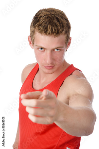 smiling athletic man pointing his finger at you. isolated