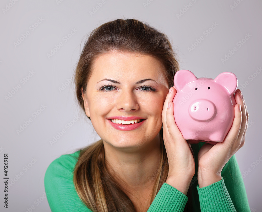 Young beautiful woman with piggy bank (money box) Young beautiful woman with piggy bank (money box)