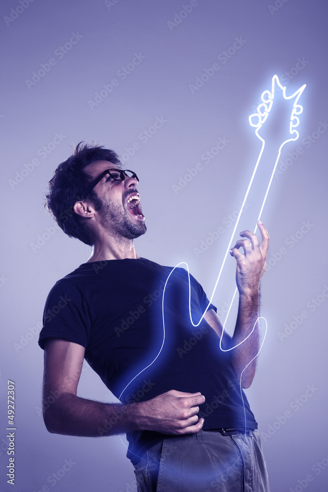 Young man playing imaginary guitar and squealing Young man playing imaginary guitar and squealing