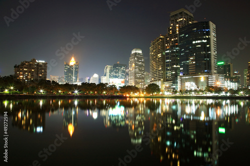 Bangkok urban scene at night with skyline reflection
