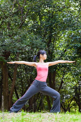 attractive asian woman stretching the park