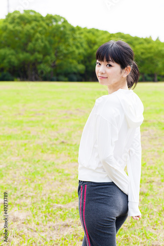 attractive asian woman relaxing in the park © taka