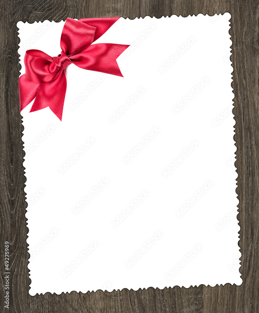 Obraz premium blank paper sheet with red bow