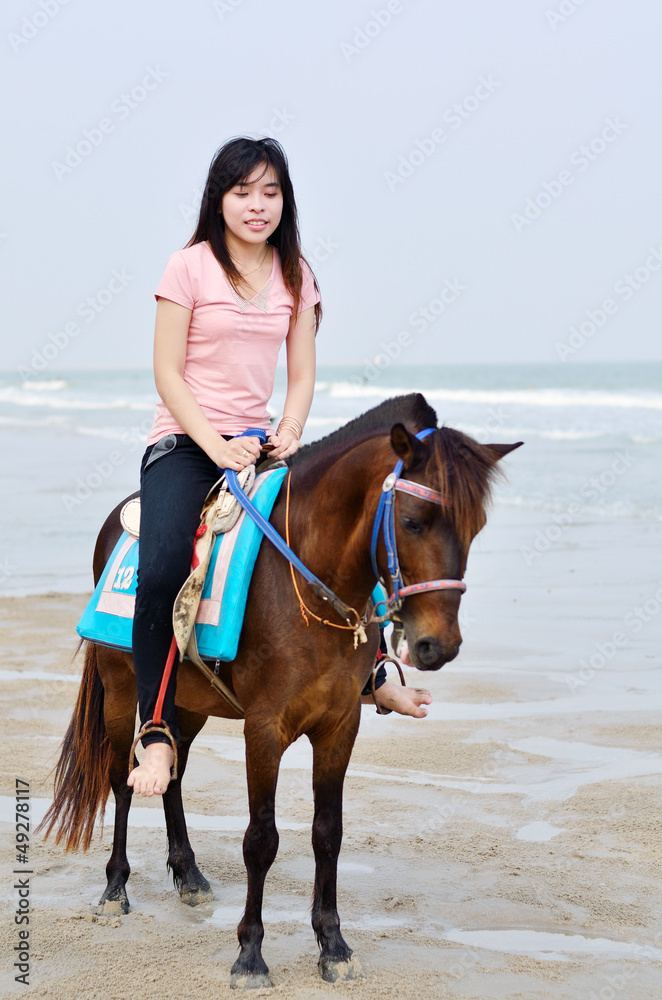 beautiful asian woman with brown horse on beach beautiful asian woman with brown horse on beach