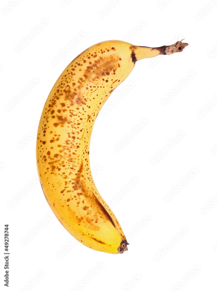 Ripe, spotted banana isolated against a white background