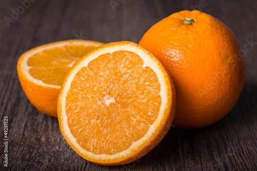 Close-up of orange fruit on wooden table.