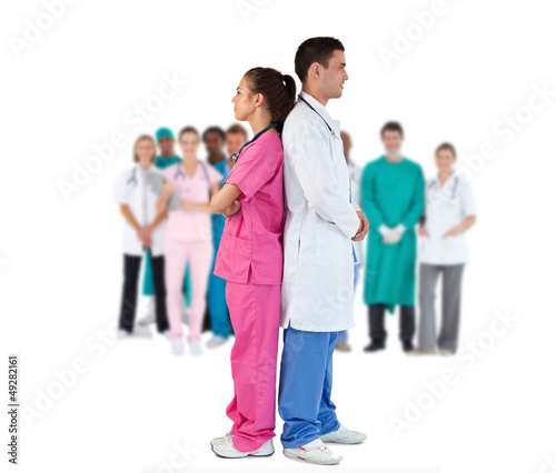 Doctor and nurse standing back to back