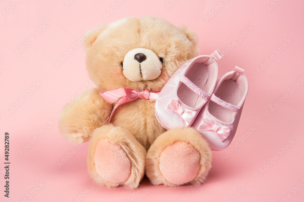 Fluffy teddy with pink ribbon and baby booties