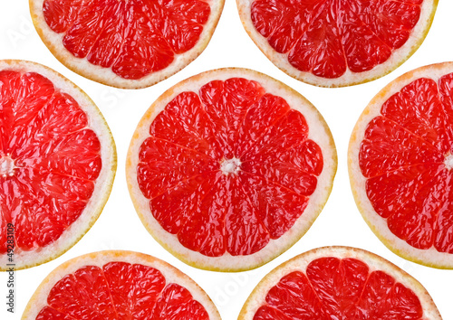 Food background - Sliced grapefruit, isolated over white