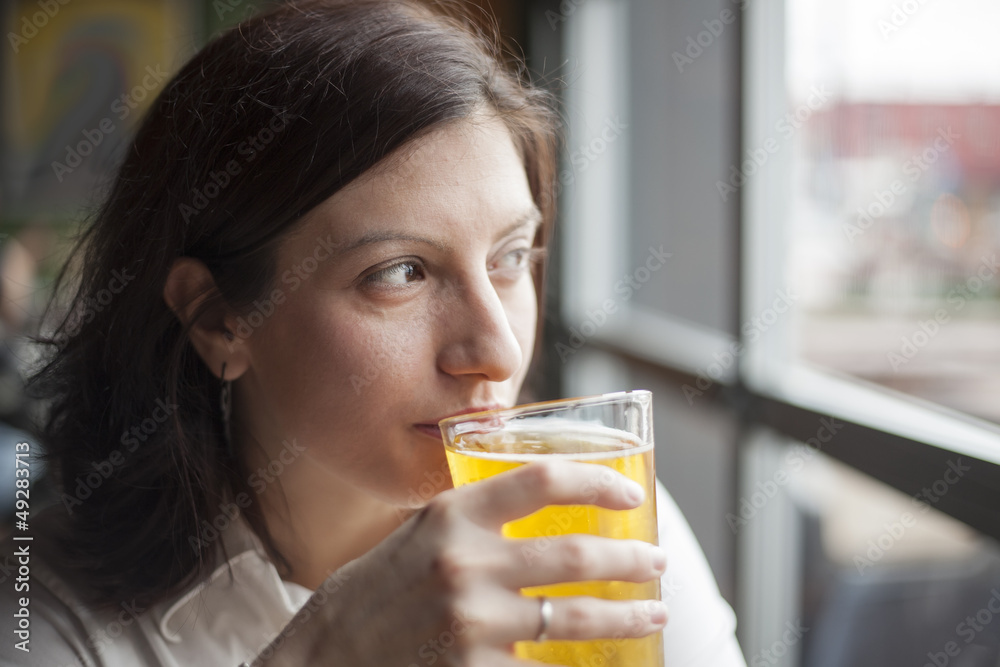 Young Woman Drinking a Pint of Hard Cider